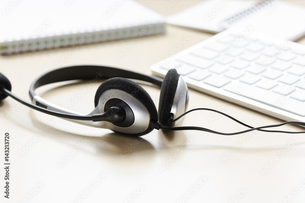 headset and keyboard on workdesk for call center concept