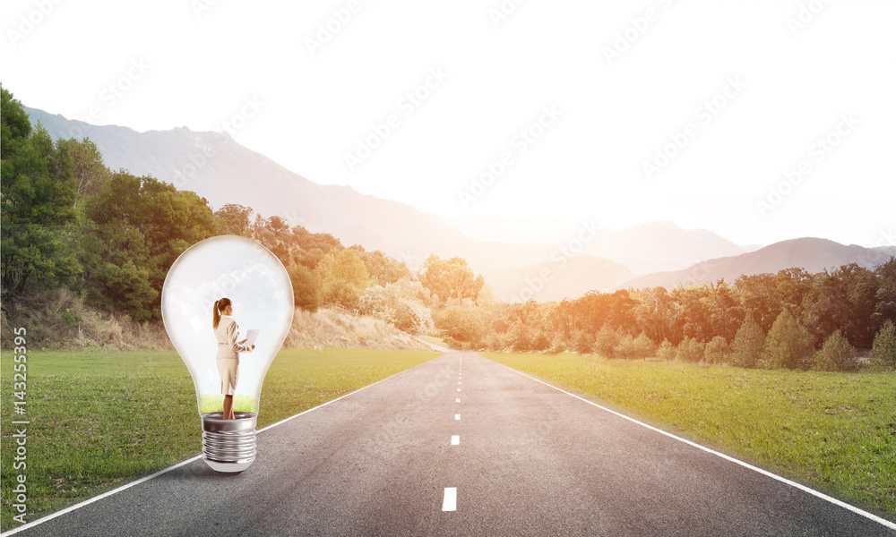 Businesswoman inside light bulb