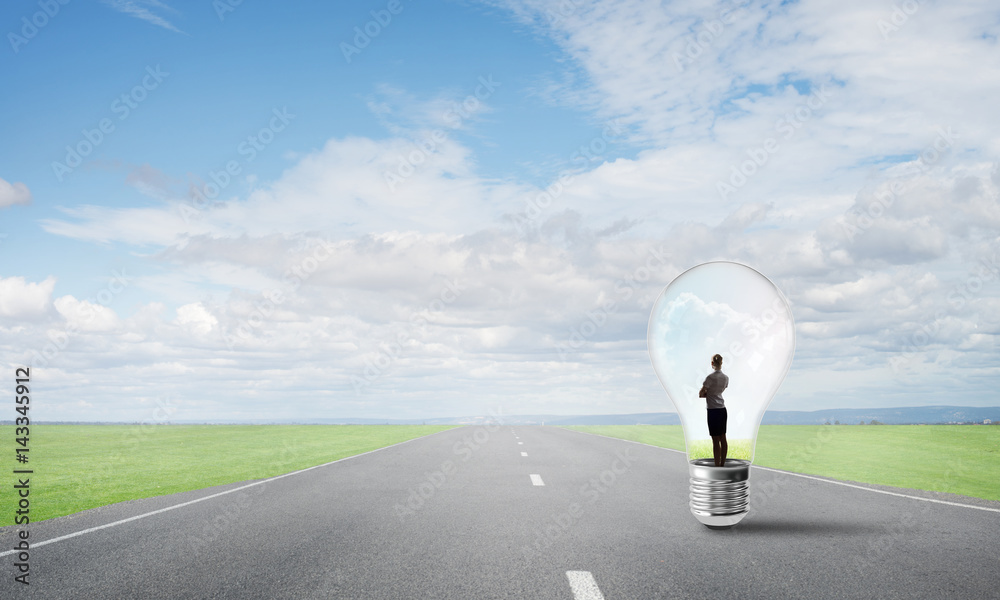 Businesswoman inside light bulb