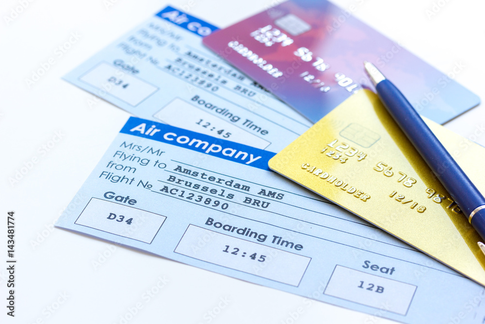 flight tickets payment online with cards on light wooden table