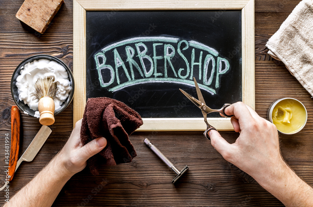 Tools for cutting beard in barbershop on workplace background top view