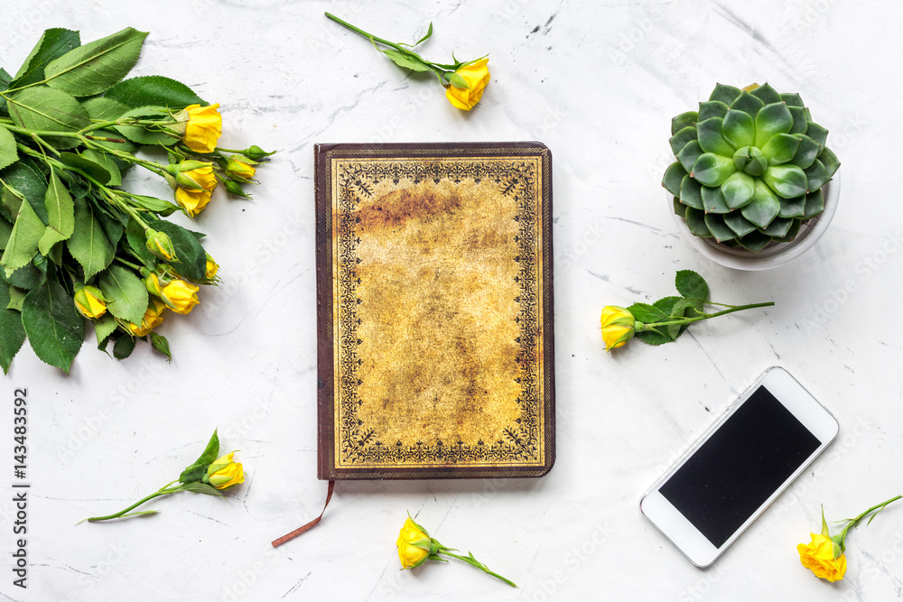 trendy office desk with roses marble background top view