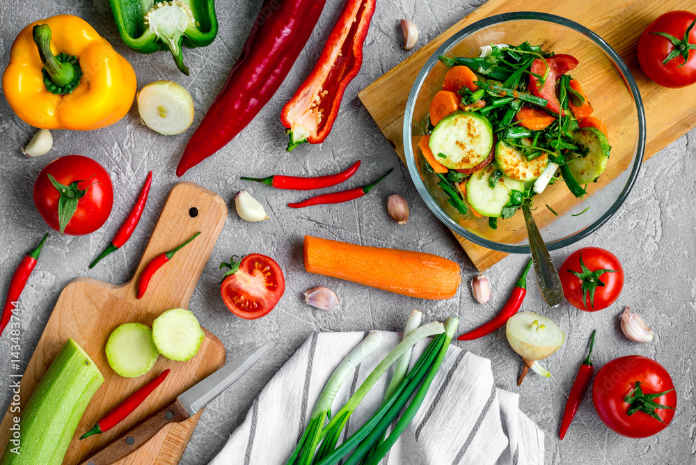 cooking vegetables on the stone background top view