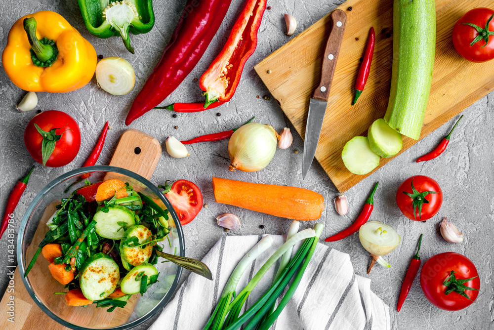 cooking vegetables on the stone background top view