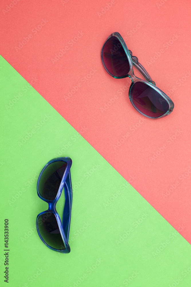 beach sunglasses on colorful paper background.