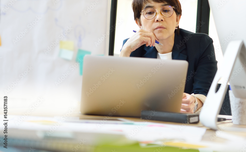 Senior businesswoman with a laptop computer in the office