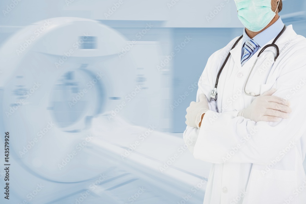 Midsection of doctor standing by CT scanner in hospital