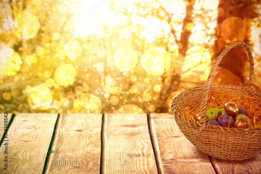 Composite image of easter eggs in paper nest basket