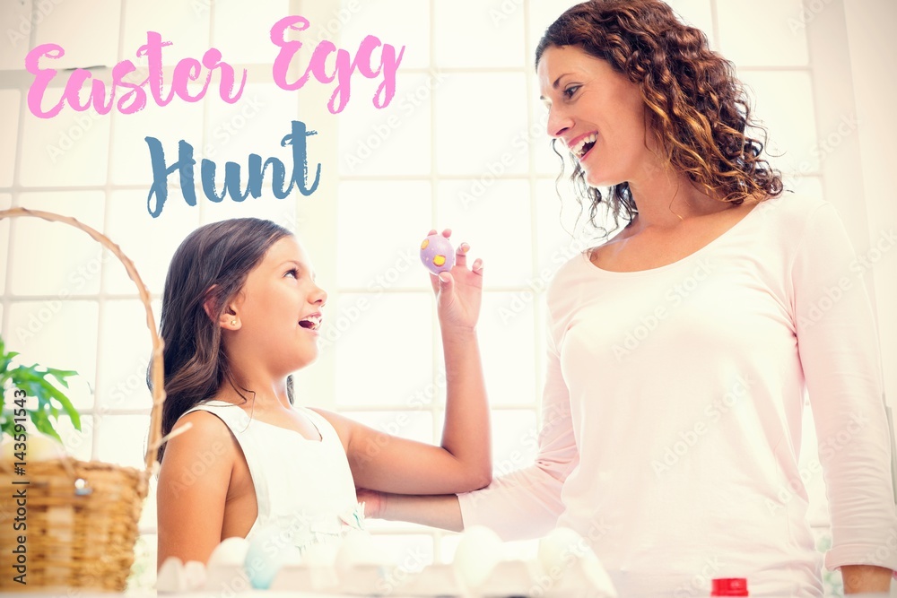 Composite image of happy girl showing easter egg to her mother 