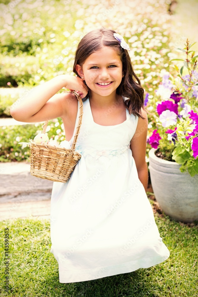 Happy girl collecting easter eggs 