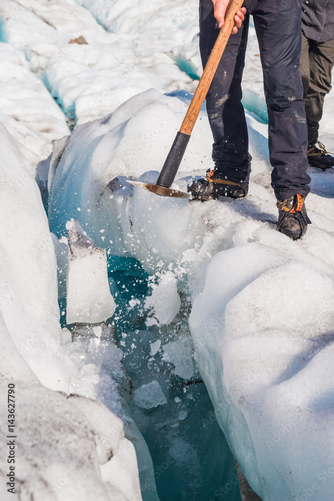 Guide to break the glaciers, Walking through glacier tunnel with guide using ice pick. Fox Glacier, 