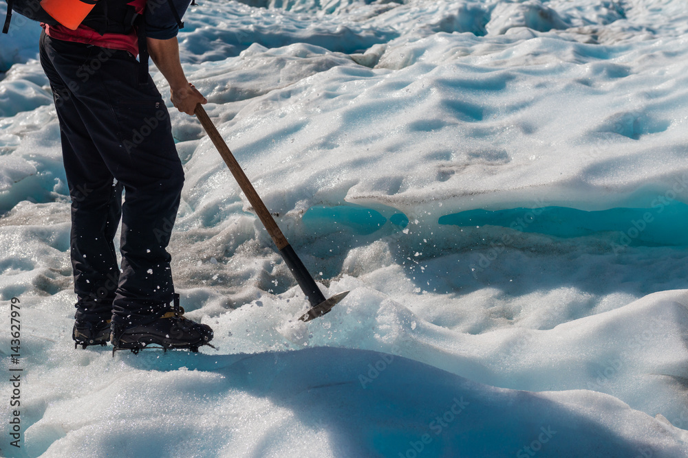 Guide to break the glaciers, Walking through glacier tunnel with guide using ice pick. Fox Glacier, 