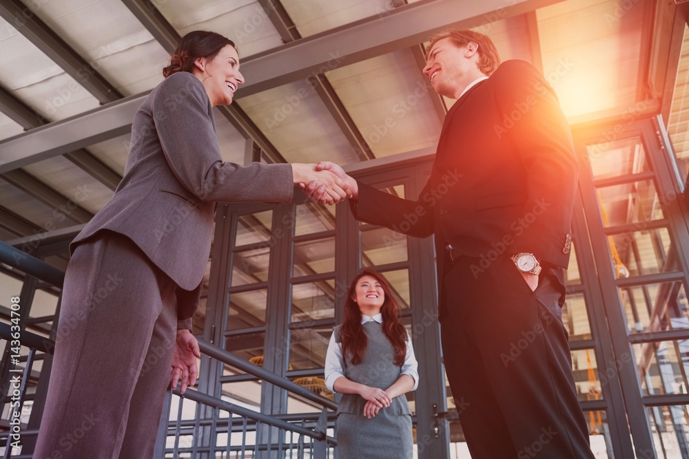 Businessman shaking hands with female partner