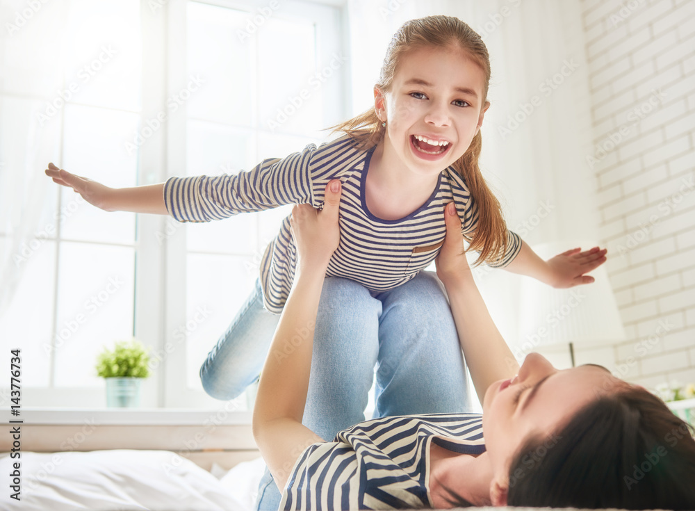 Mom and her daughter are playing