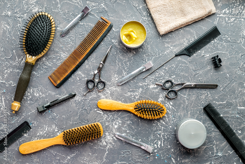 styling hair with tools in barbershop on gray background top view