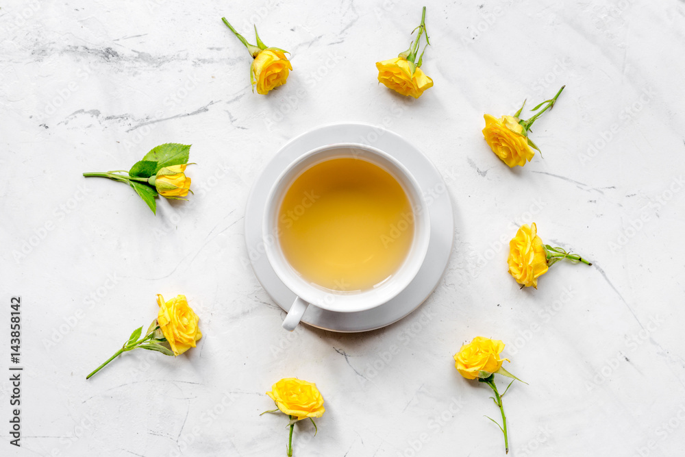 spring flatlay with flowers and cup of tea top view