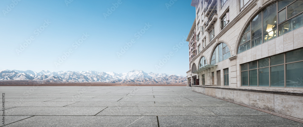 empty brick floor with white snow mountain