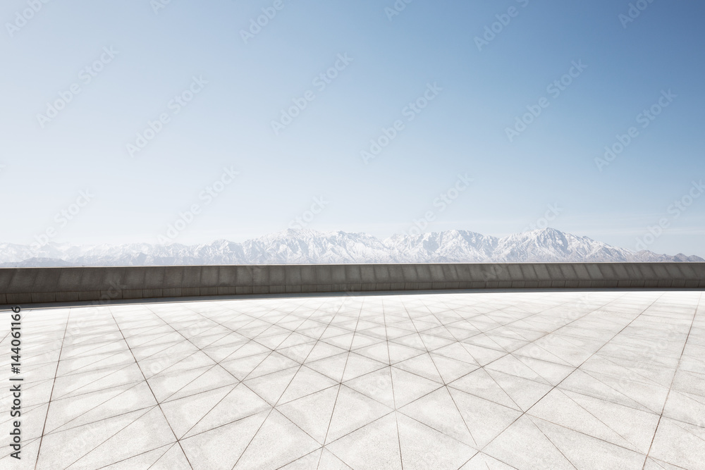 empty brick floor with white snow mountain