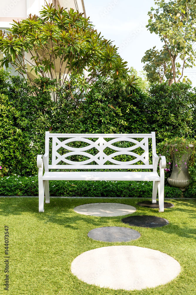 White wood bench chair with bush Background in garden at home.