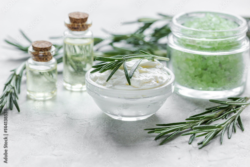 organic cosmetics with rosemary extract on stone table background