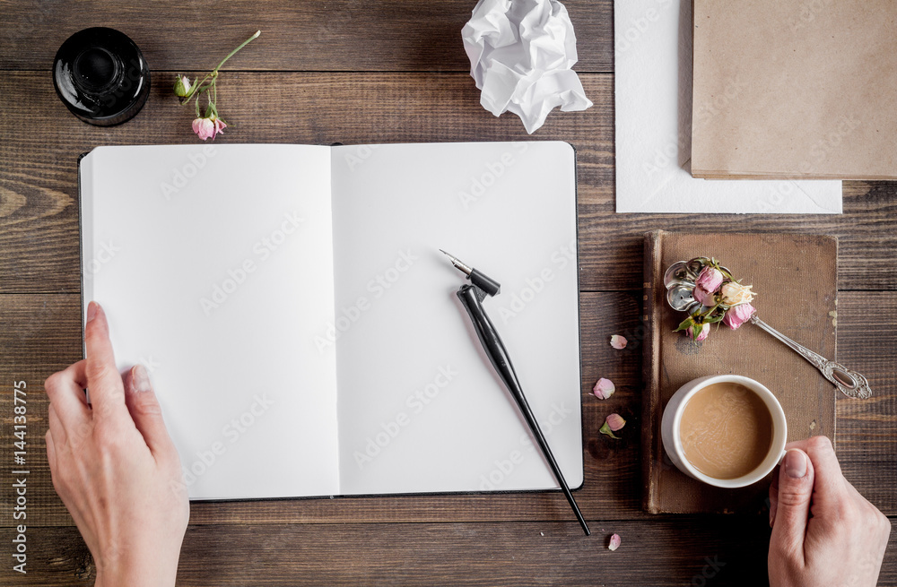 Writer workplace with tools on wooden background top view