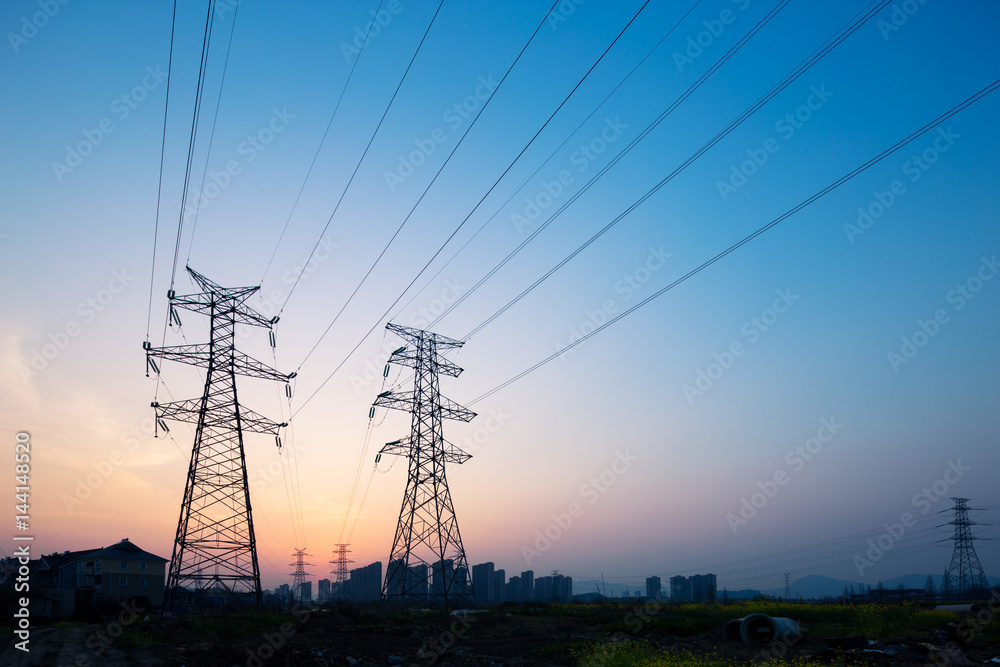 pylons in blue sky at sunrise