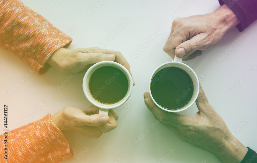 People hands holding coffee cup in aerial view