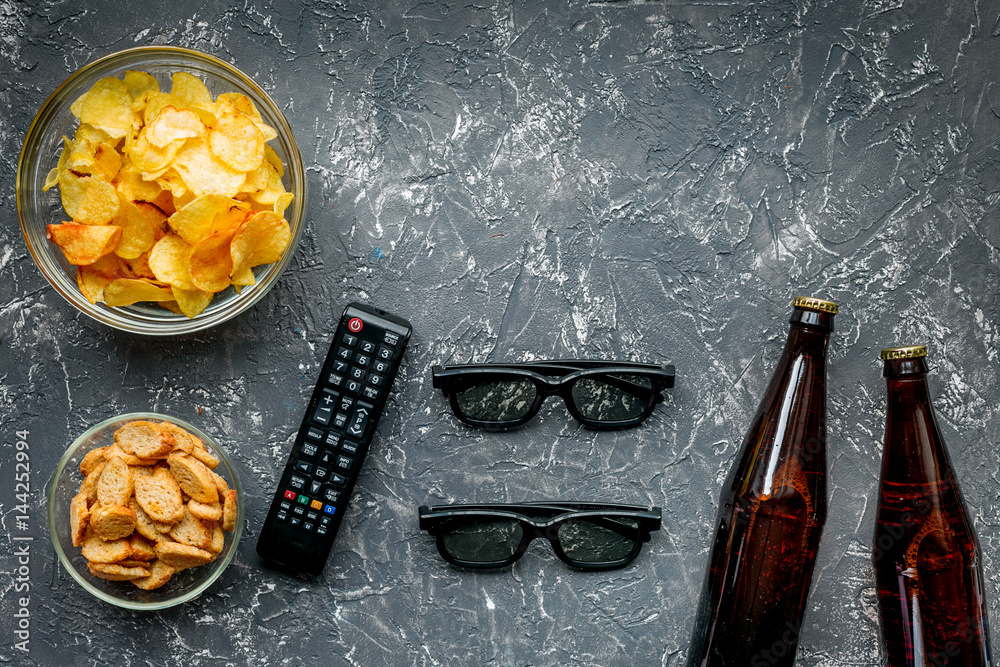 watching movies concept with chips on dark background top view mock up