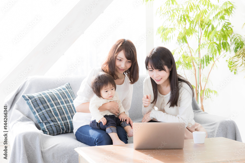 young asian family using laptop in living room