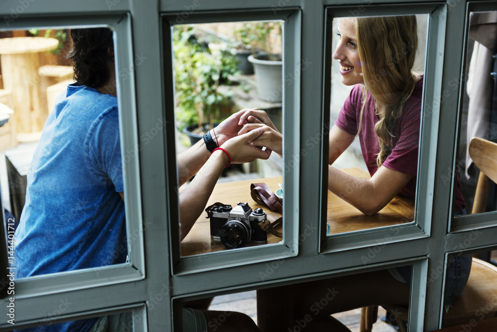 Couple date restaurant holding hands