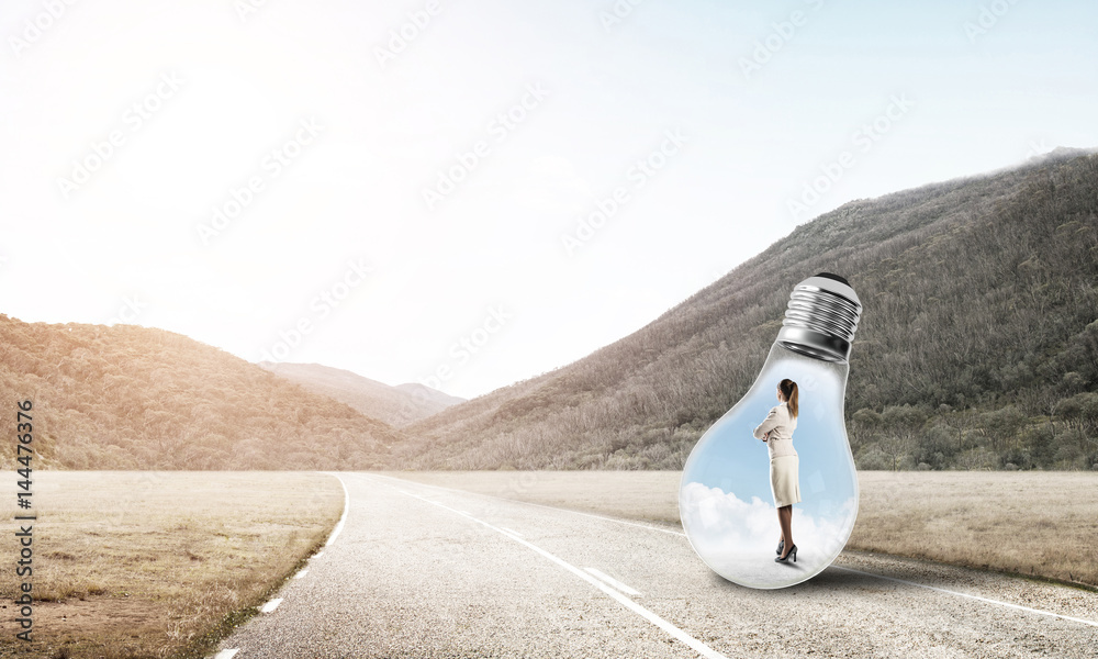 Businesswoman inside light bulb