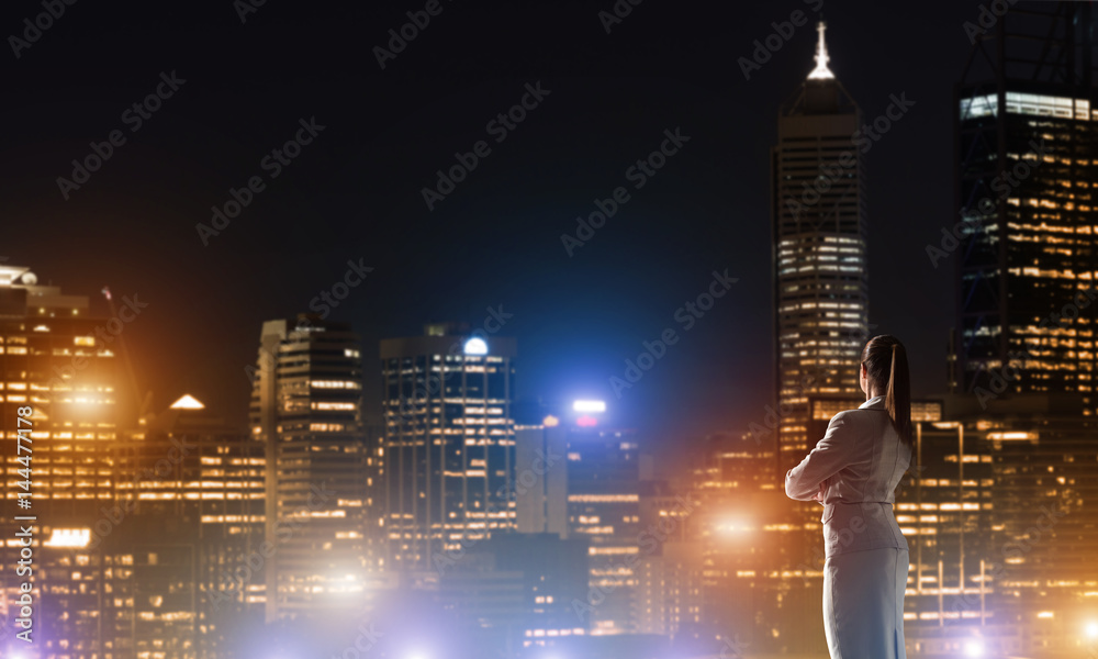 Woman looking at night city