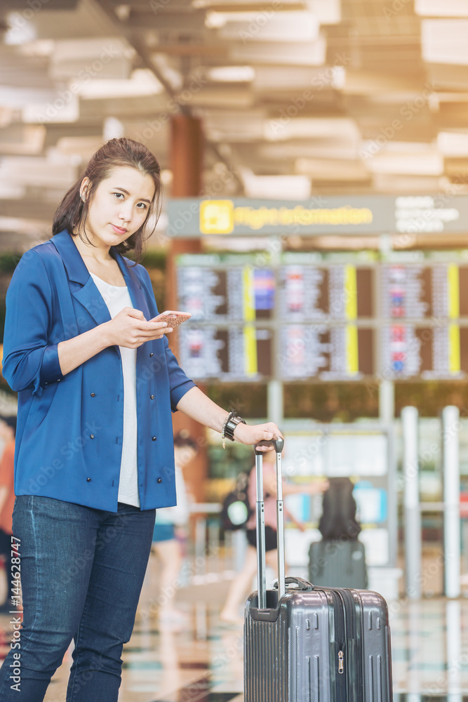 Tourist woman with luggage in the airport