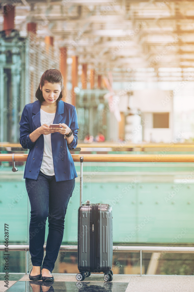 Tourist woman in the airport terminal with luggage