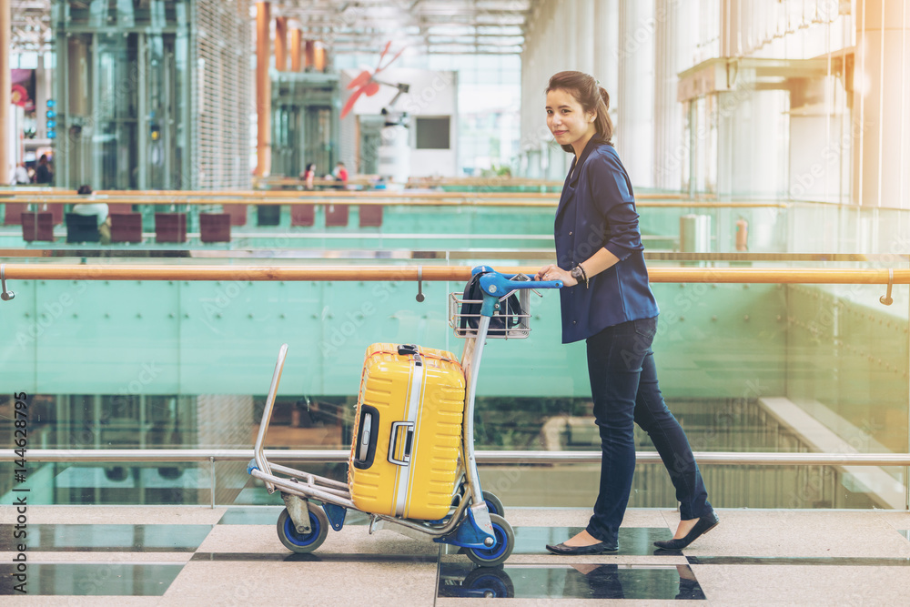 Tourist woman in the airport terminal with luggage