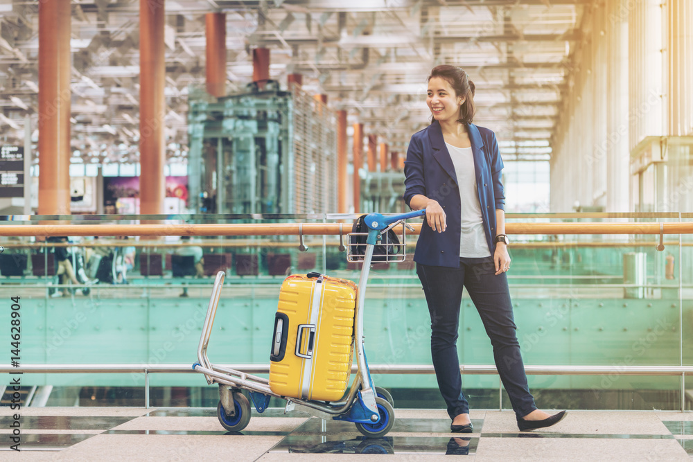 Tourist woman in the airport terminal with luggage