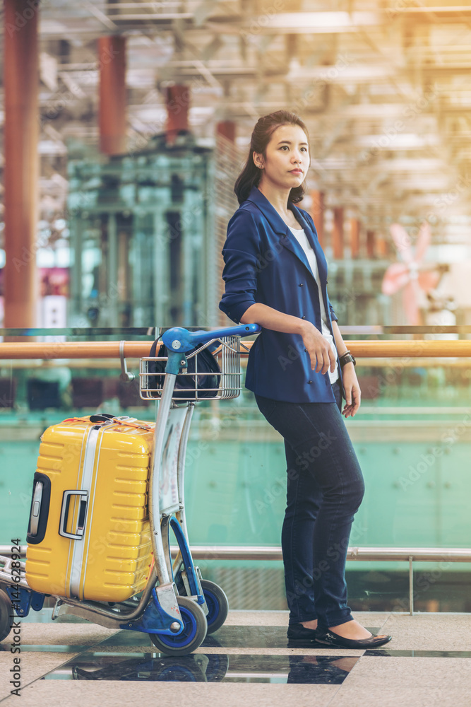 Tourist woman in the airport terminal with luggage