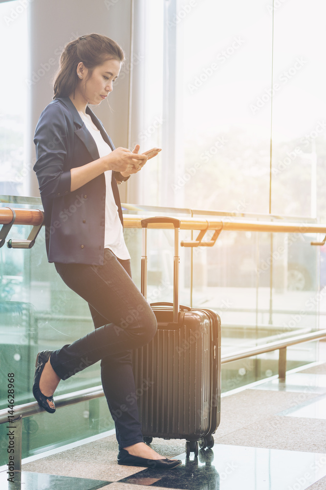 Tourist woman in the airport terminal with luggage