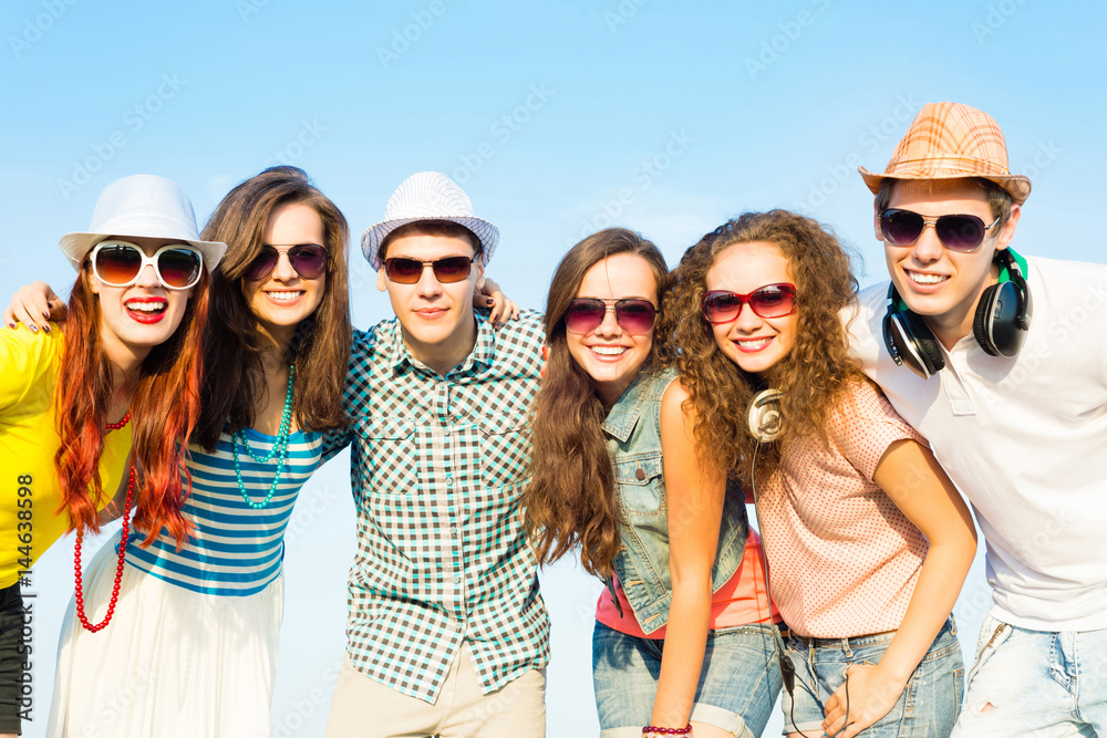 group of young people wearing sunglasses and hat