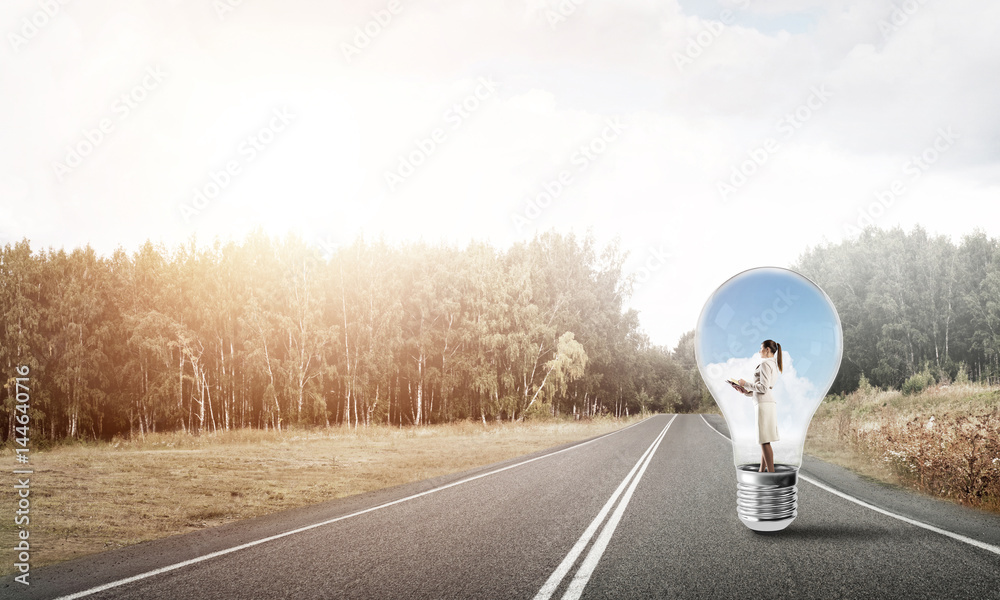 Businesswoman inside light bulb