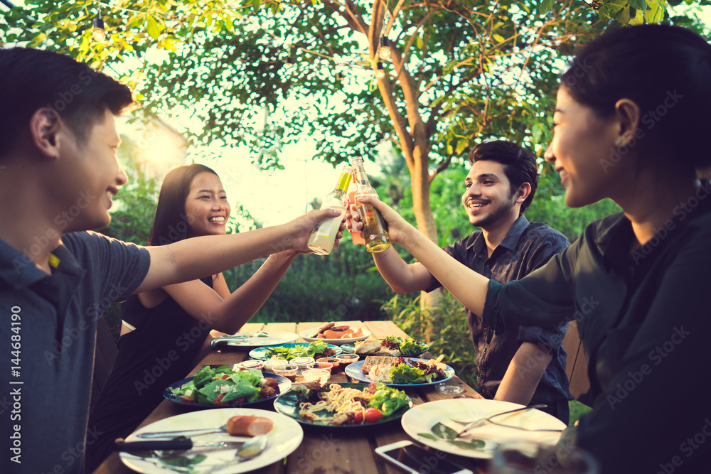 People in asian are celebrating the festival they clink beer and dinner outdoor they are happy