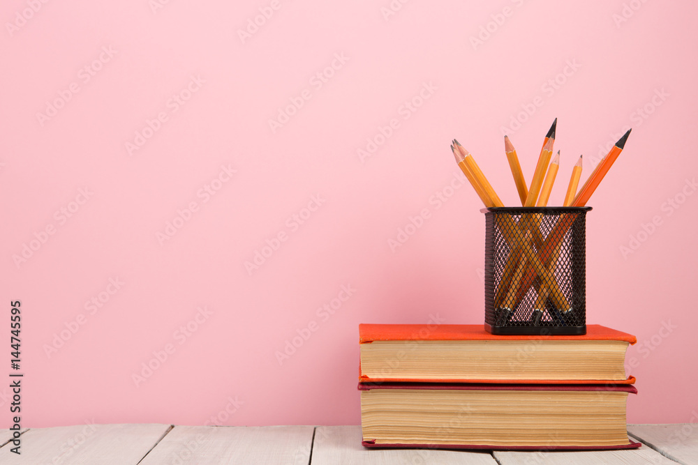 education and wisdom concept - books on wooden table, color background