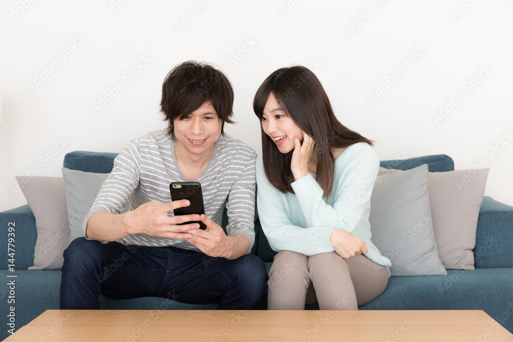 young asian couple relaxing in living room