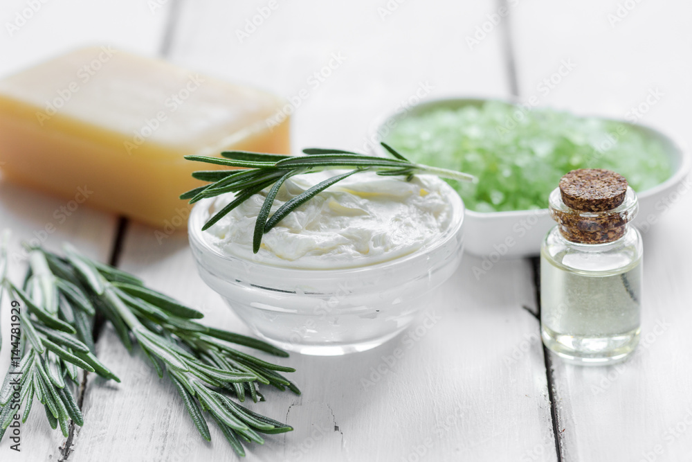 natural essential aroma oil with rosemary on wooden table background