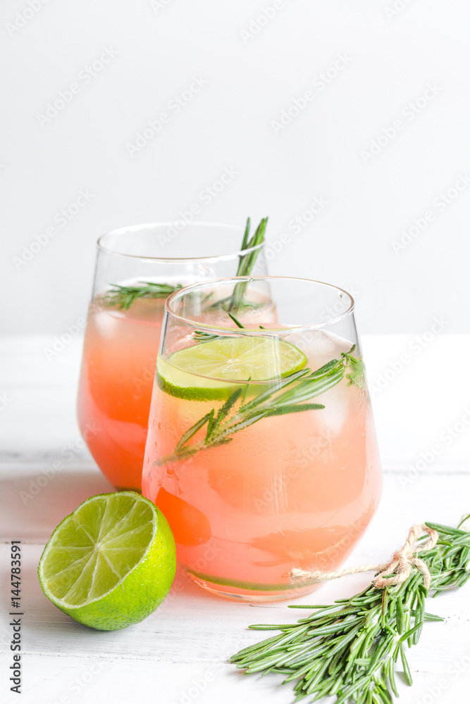 healthy morning with fresh drink, lime and rosemary on white table background