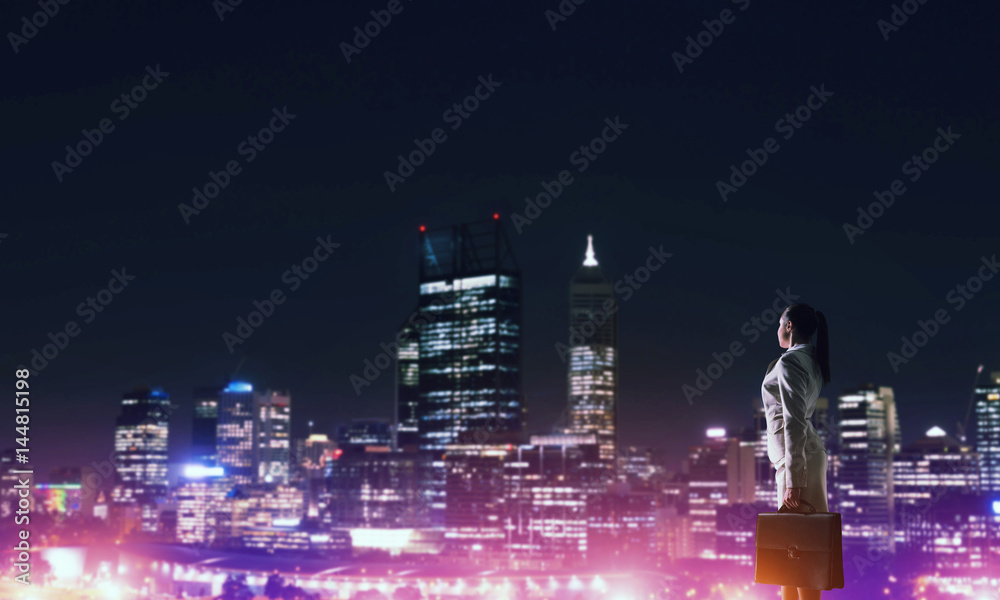 Woman looking at night city