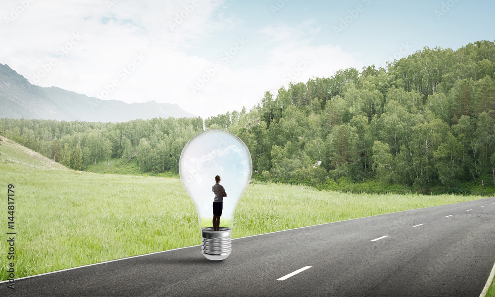 Businesswoman inside light bulb