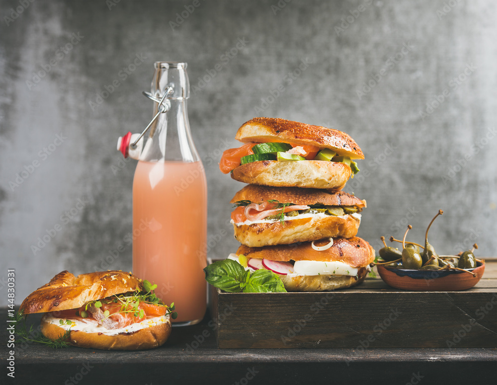 Bagels with salmon, eggs, vegetables, capers and cream-cheese and bottle of grapefruit lemonade, gre