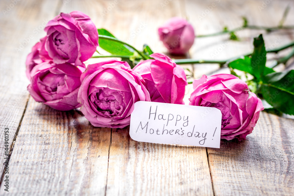 present design with Mothers day text and greeting-card on wooden desk