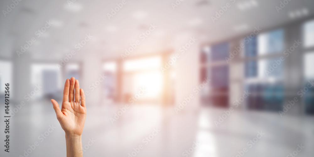 Choosing gesture of person in elegant modern interior in sunshine light